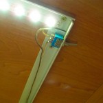 Профиль с LED тесьмой монтируется к шкафу с помощью саморезов или приклеивается